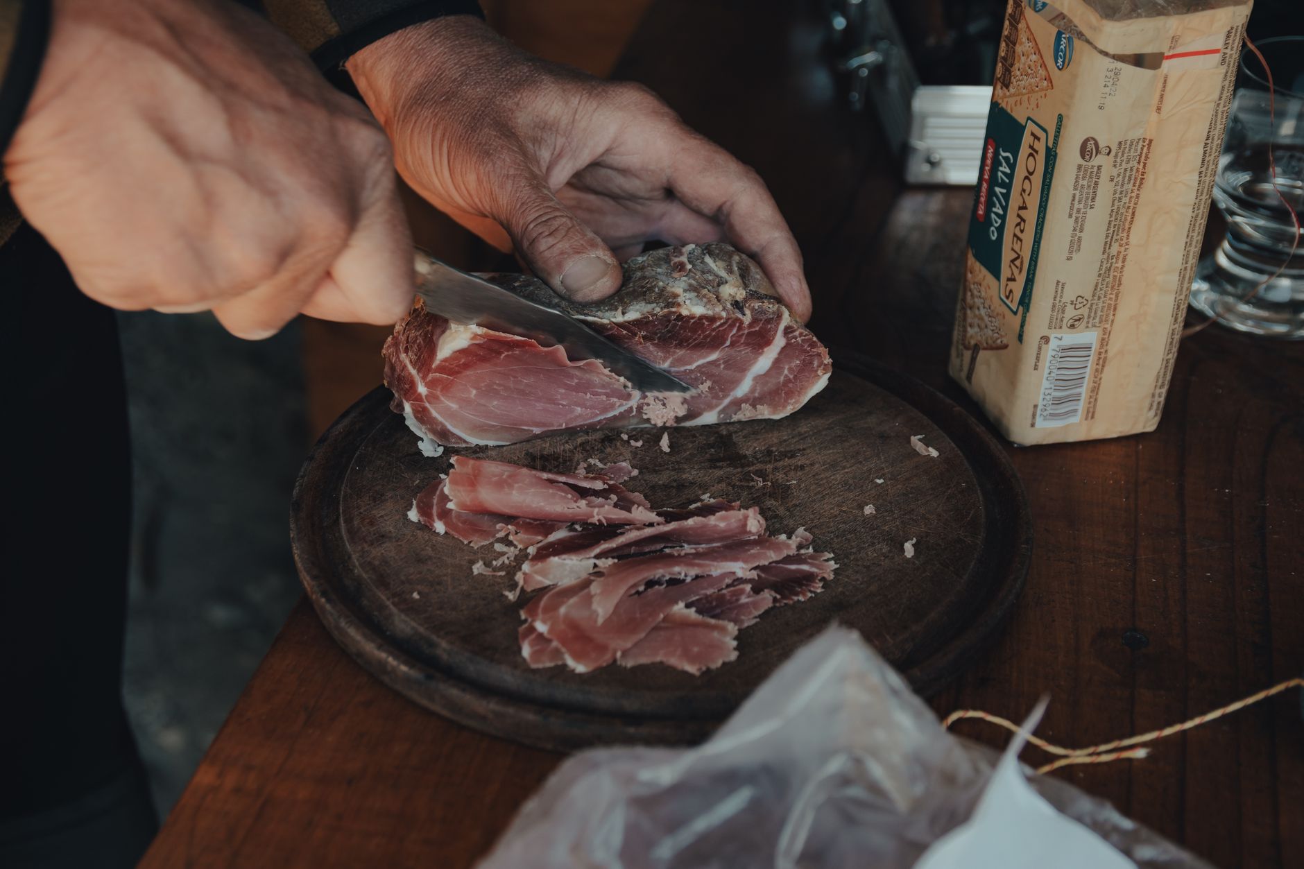 a person slicing meat